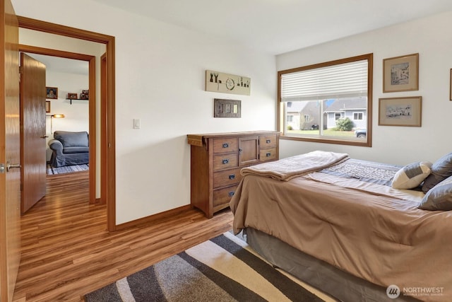 bedroom featuring baseboards and light wood finished floors
