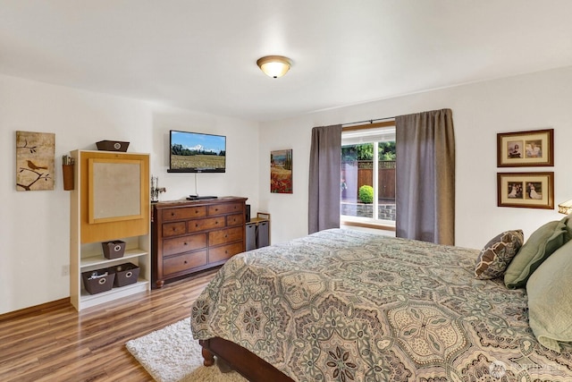bedroom featuring baseboards and wood finished floors