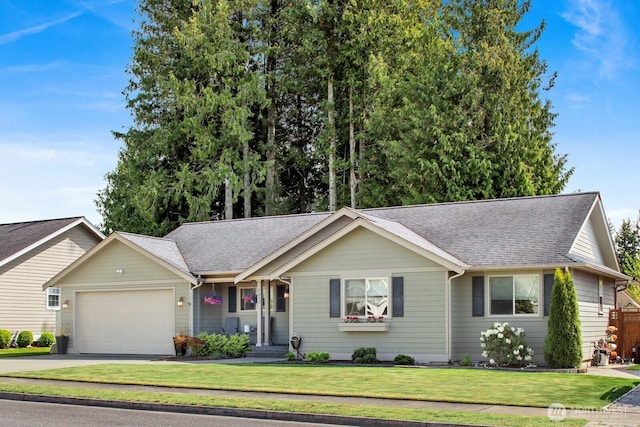 ranch-style house with roof with shingles, a front yard, an attached garage, and driveway
