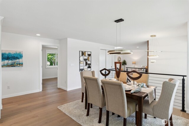 dining area with wood finished floors, baseboards, and recessed lighting