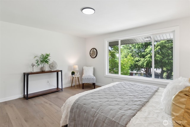 bedroom featuring wood finished floors and baseboards