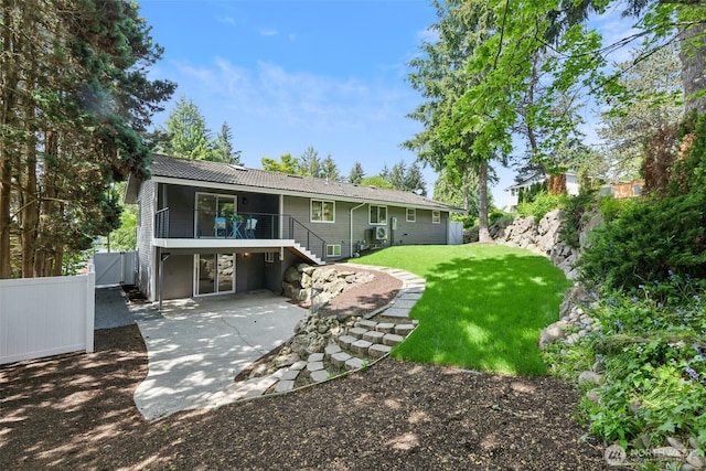 rear view of property featuring a patio, stairway, and a wooden deck