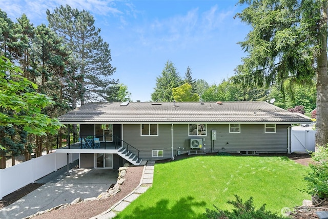 rear view of property featuring a patio area, stairs, and a gate