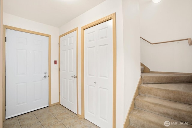1140 N 92nd Unit B, Seattle, WA 98103 - entryway with light tile patterned floors, stairway, and baseboards