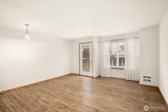 1140 N 92nd Unit B, Seattle, WA 98103 - empty room with light wood-style flooring, baseboards, and heating unit