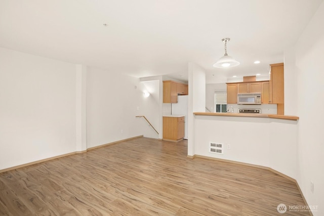 1140 N 92nd Unit B, Seattle, WA 98103 - unfurnished living room with light wood-style floors, recessed lighting, and baseboards