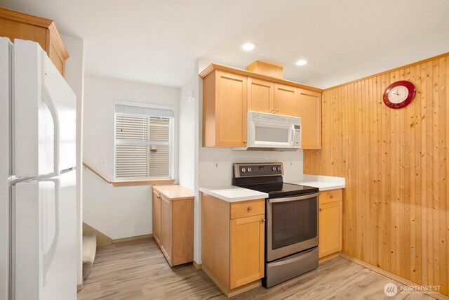 1140 N 92nd Unit B, Seattle, WA 98103 - kitchen with white appliances, light wood-style floors, light countertops, light brown cabinets, and recessed lighting