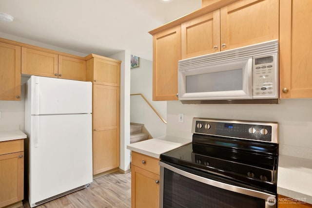 1140 N 92nd Unit B, Seattle, WA 98103 - kitchen featuring white appliances, light brown cabinetry, light wood finished floors, and light countertops