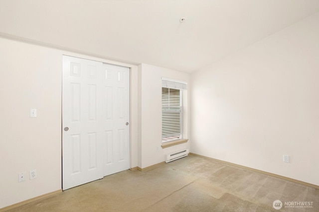 1140 N 92nd Unit B, Seattle, WA 98103 - unfurnished bedroom featuring a baseboard radiator, carpet, baseboards, and a closet