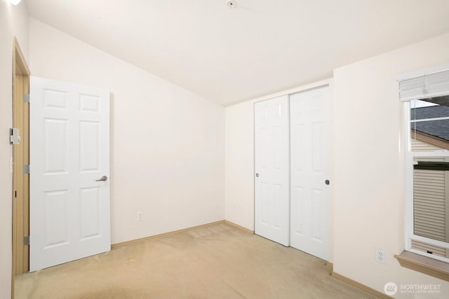 1140 N 92nd Unit B, Seattle, WA 98103 - unfurnished bedroom featuring carpet flooring, baseboards, a closet, and vaulted ceiling