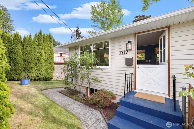 doorway to property with a yard