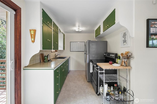 kitchen with green cabinetry, range with electric stovetop, a sink, light countertops, and backsplash