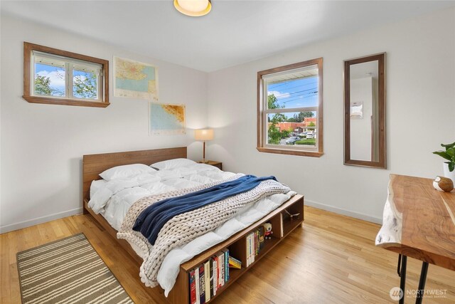 bedroom with wood finished floors and baseboards