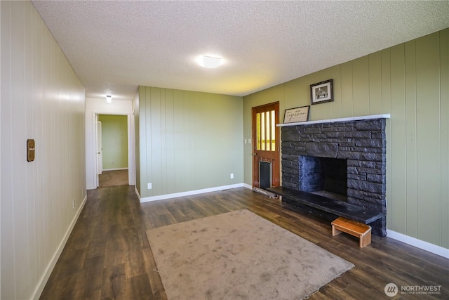 1234 Friedlander Dr, Aberdeen, WA 98520 - unfurnished living room with wood finished floors, a fireplace, a textured ceiling, and baseboards