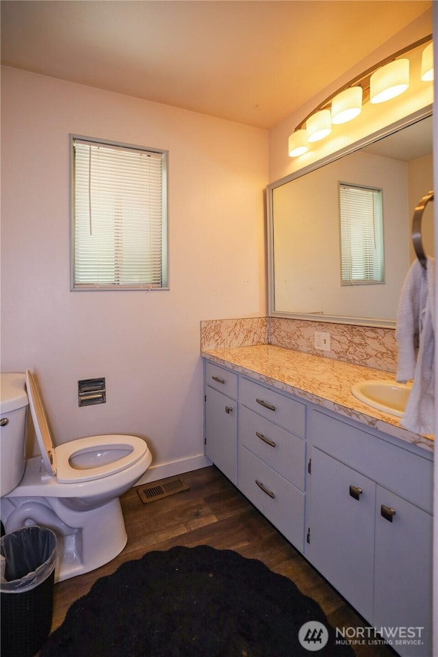 1234 Friedlander Dr, Aberdeen, WA 98520 - bathroom with toilet, wood finished floors, vanity, and baseboards