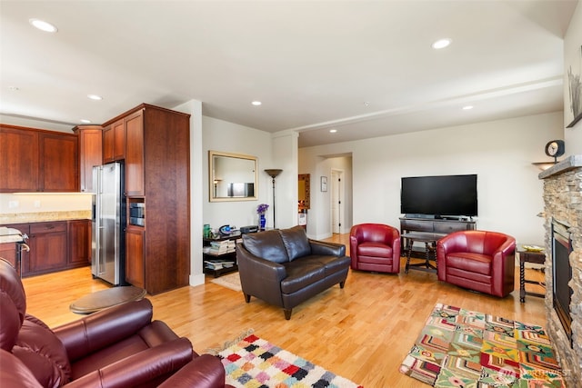 1215 Lawrence St Unit 201, Port Townsend, WA 98368 - living room featuring light wood-style flooring, a fireplace, and recessed lighting