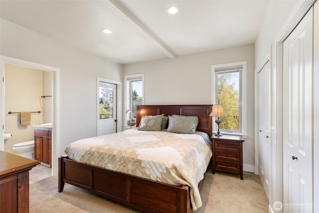 1215 Lawrence St Unit 201, Port Townsend, WA 98368 - bedroom featuring light colored carpet, ensuite bath, recessed lighting, and beam ceiling