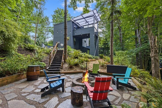 view of patio / terrace with a fire pit and stairs