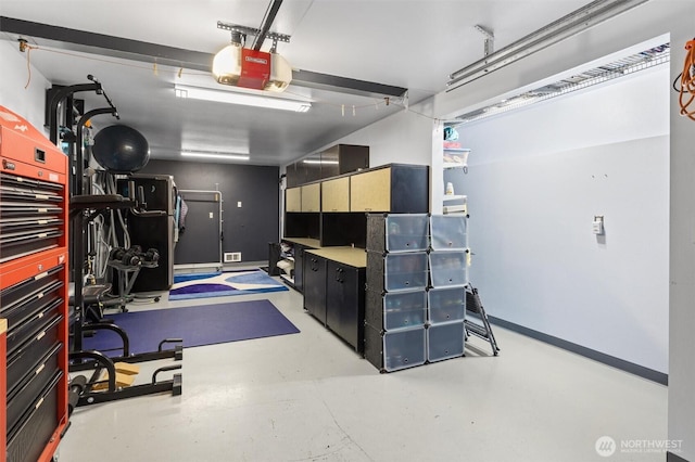 garage with a garage door opener and baseboards