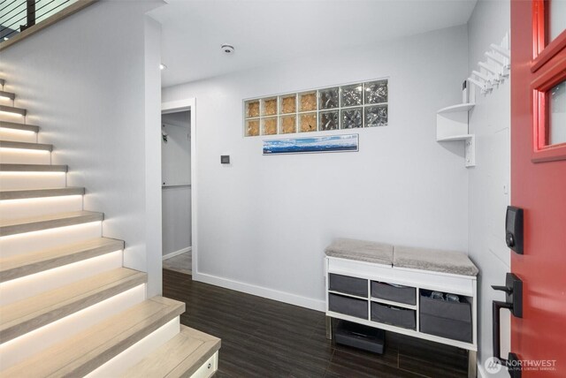 staircase with baseboards, wood finished floors, and recessed lighting