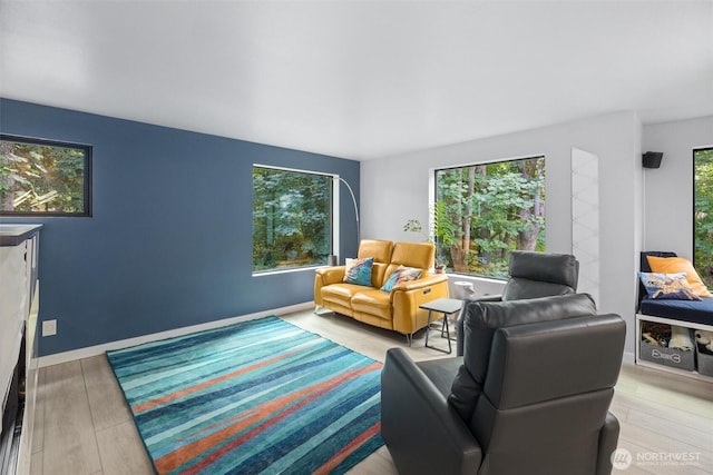 living area with plenty of natural light and wood finished floors