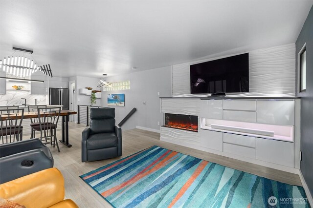 living area with light wood finished floors and a fireplace