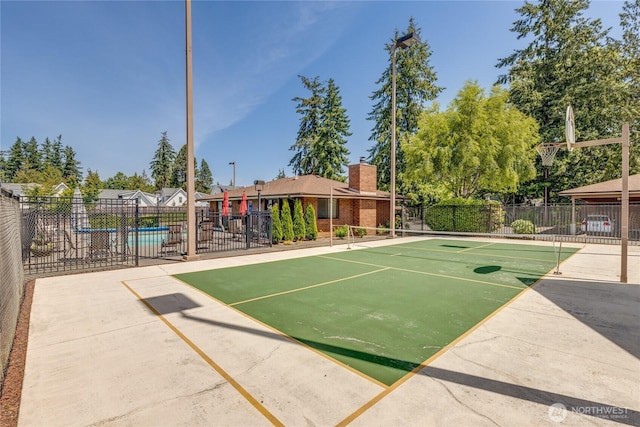 view of community with fence and a swimming pool