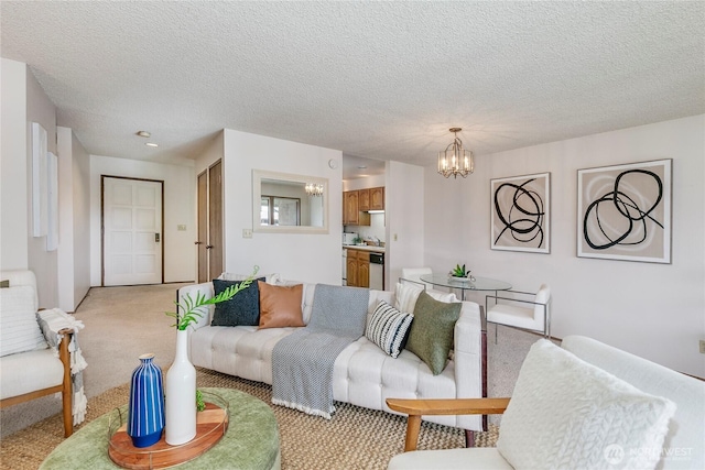 living room with a chandelier, light carpet, and a textured ceiling