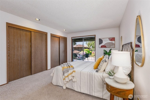 carpeted bedroom featuring two closets, a textured ceiling, access to outside, and recessed lighting