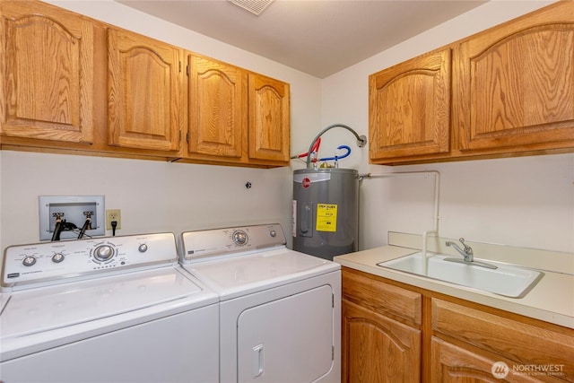washroom with water heater, washer and dryer, and cabinet space