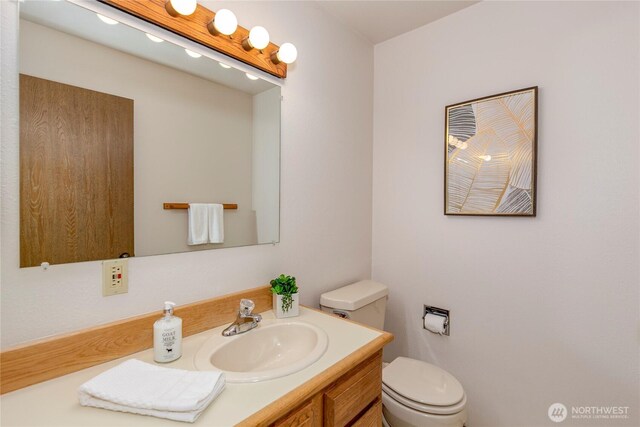 bathroom with toilet and vanity