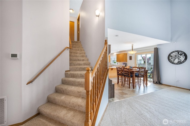 9006 190th St E, Puyallup, WA 98375 - stairway featuring a towering ceiling, baseboards, and carpet flooring