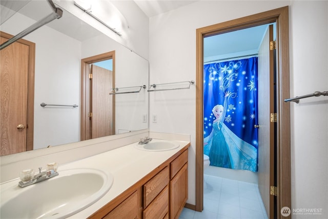 9006 190th St E, Puyallup, WA 98375 - bathroom featuring toilet, double vanity, a shower with curtain, and tile patterned flooring