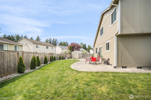 9006 190th St E, Puyallup, WA 98375 - view of yard featuring a shed, an outbuilding, a patio, and a residential view