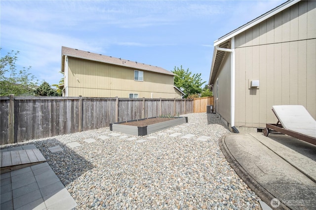 9006 190th St E, Puyallup, WA 98375 - fenced backyard with a garden, a patio area, and central AC