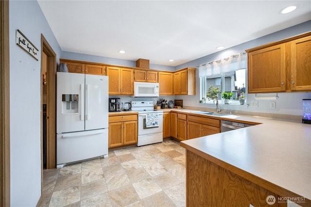 9006 190th St E, Puyallup, WA 98375 - kitchen with white appliances, a sink, brown cabinets, light countertops, and recessed lighting