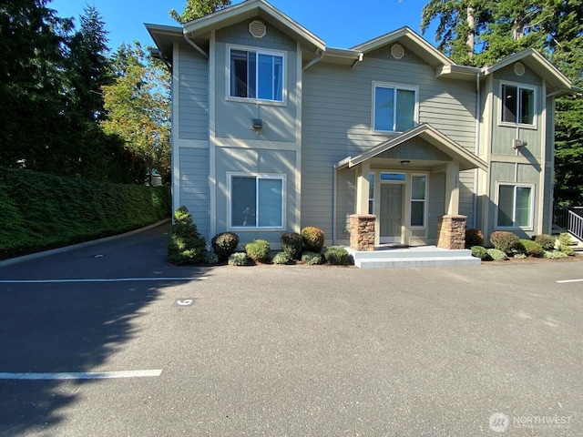 view of front of home featuring uncovered parking and covered porch