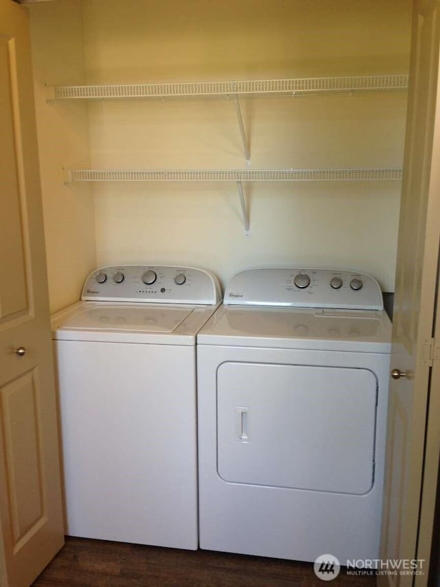laundry room with washing machine and clothes dryer, laundry area, and dark wood-style flooring