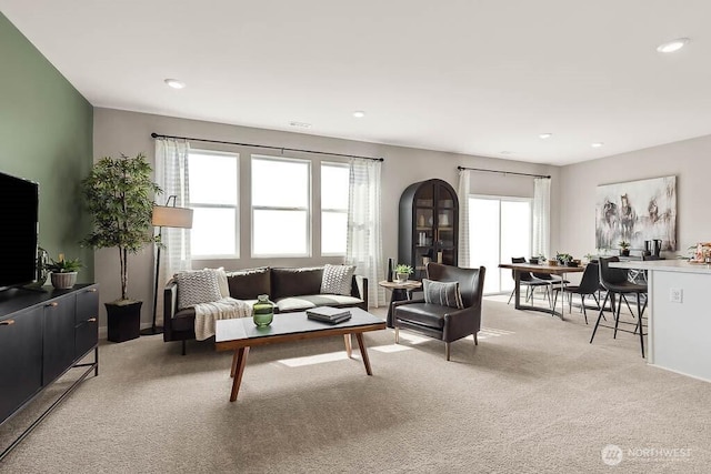 living room with light carpet and recessed lighting