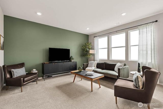 living room with baseboards, visible vents, recessed lighting, and light colored carpet
