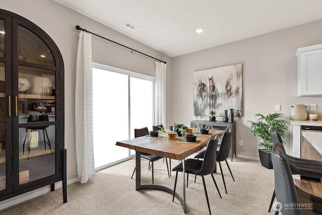 dining room with recessed lighting, visible vents, baseboards, and light carpet
