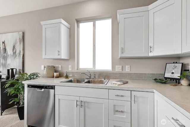 kitchen featuring dishwasher, a wealth of natural light, light countertops, and a sink