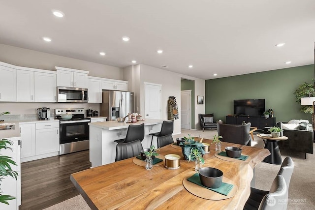 dining space with recessed lighting and wood finished floors