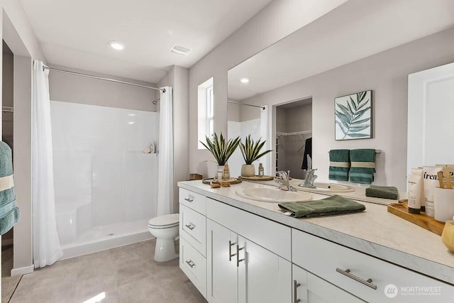 bathroom with a stall shower, recessed lighting, toilet, visible vents, and vanity