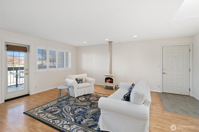 514 Bell St, Edmonds, WA 98020 - living room featuring baseboards, a wood stove, light wood finished floors, and recessed lighting
