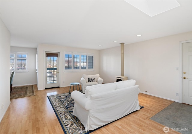 514 Bell St, Edmonds, WA 98020 - living room with baseboards, a skylight, light wood finished floors, and plenty of natural light