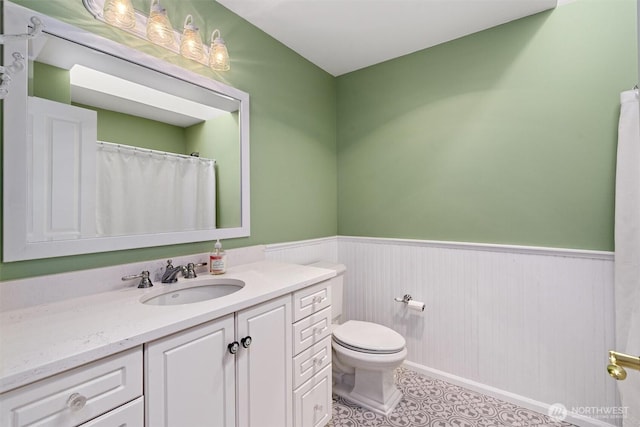 514 Bell St, Edmonds, WA 98020 - bathroom featuring toilet, vanity, and a wainscoted wall