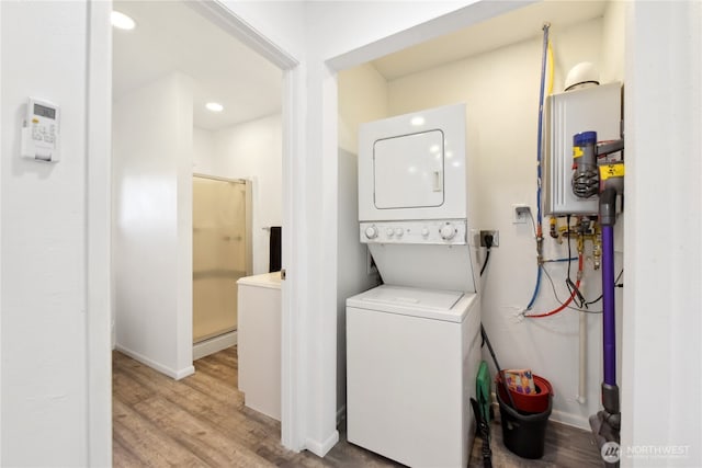 11 Ridge Loop Rd, Cle Elum, WA 98922 - laundry area with stacked washer / dryer, water heater, wood finished floors, and recessed lighting