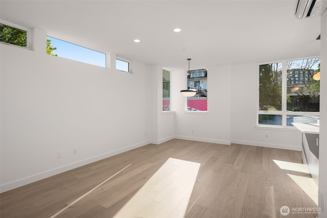 1625B 21st Ave, Seattle, WA 98122 - unfurnished dining area with light wood-type flooring, recessed lighting, an AC wall unit, and baseboards