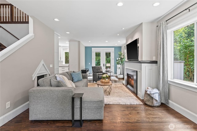 856 Hilltop Ave, Kent, WA 98031 - living room with healthy amount of natural light, a glass covered fireplace, recessed lighting, dark wood finished floors, and baseboards
